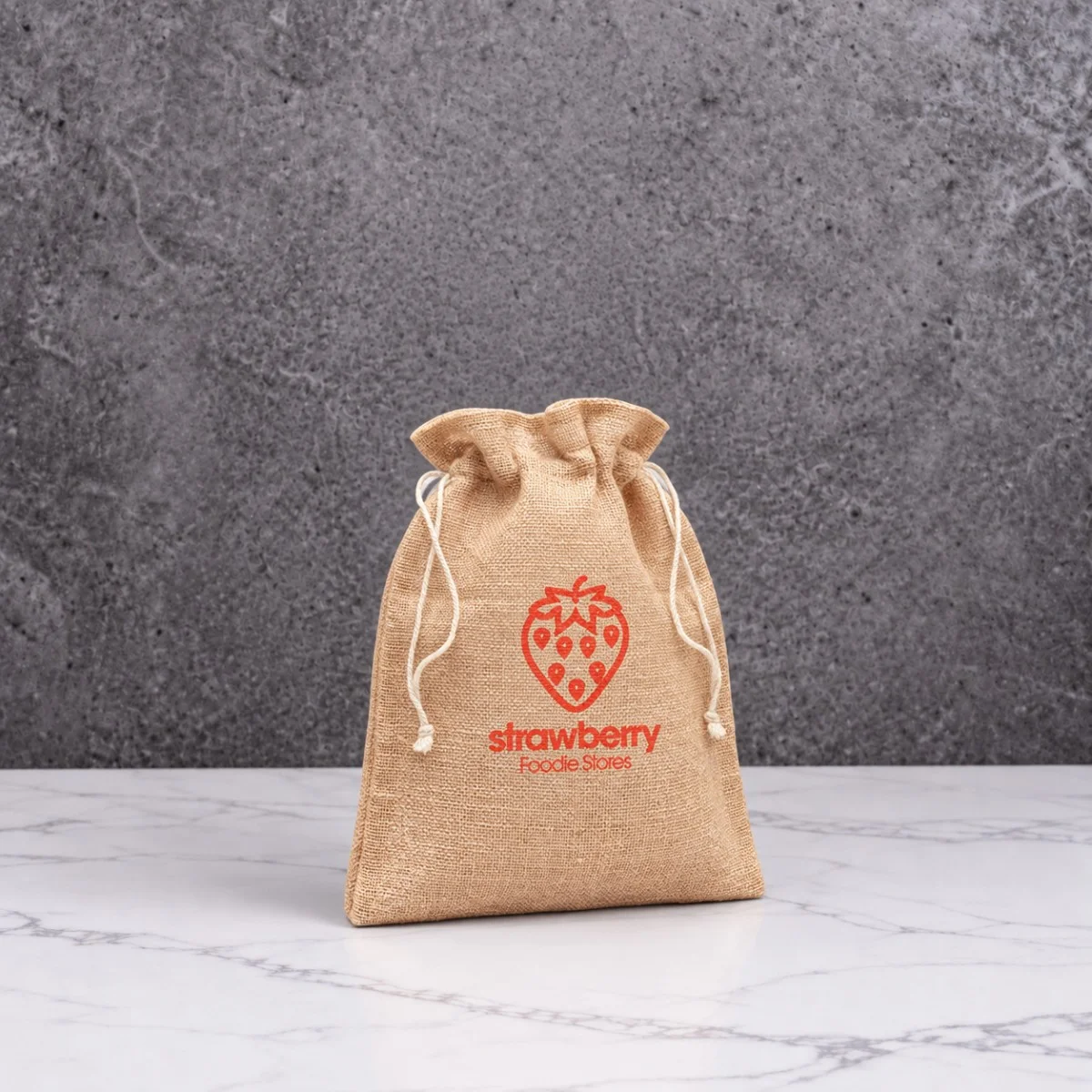 Natural jute gift pouch printed with a red Strawberry Foodie Stores design