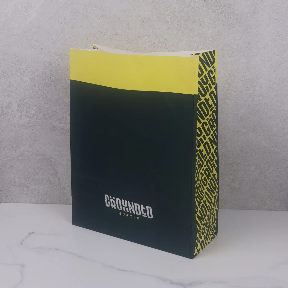 Yellow and Dark Blue Takeaway Counter Bag for Grounded Burgers Yellow and Dark Blue Takeaway Counter Bag for Grounded Burgers